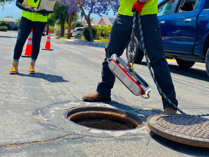 RedZone Robotics Solo robot being lowered into a sewer manhole